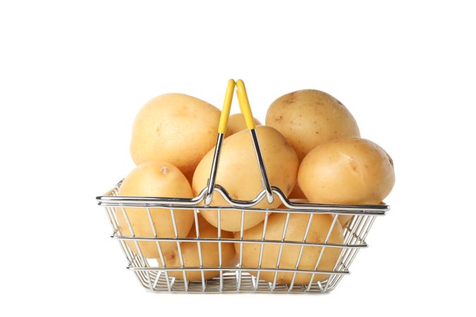 Steel basket full of potatoes, side view