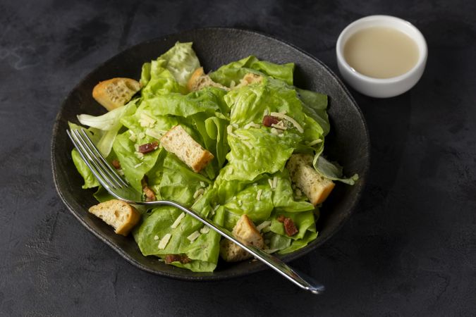 Caesar salad with croutons and bacon.
