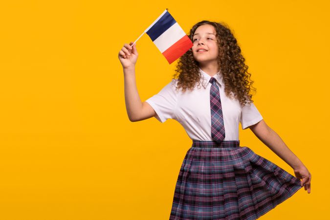 Girl waving French flag playfully