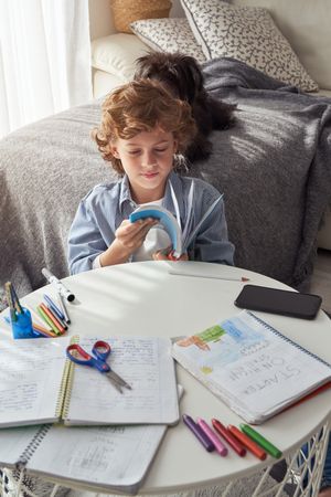 Little boy reading book at home