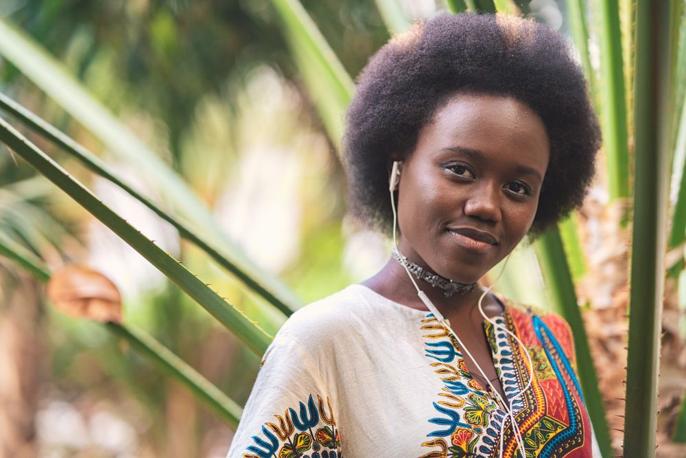 Smiling Black woman listening to music