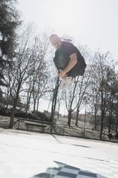 Young man in air dancing break dance in park
