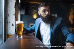 Man in suit with pint of beer 4dyOlb