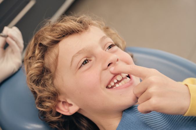 Cheerful boy on dental chair