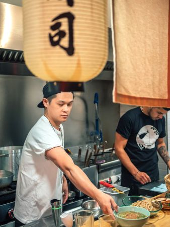 Young males working in kitchen