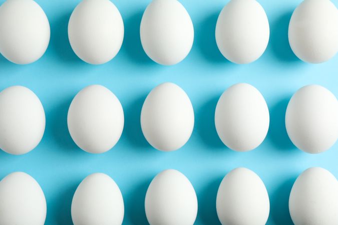 Flat lay composition with chicken eggs on color background, space for text