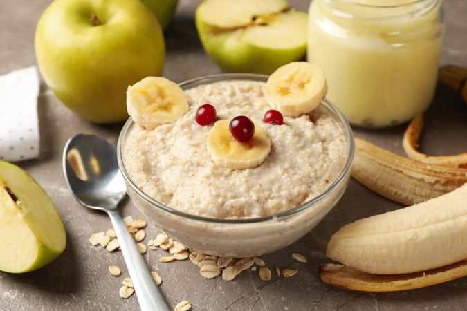 Composition with baby food on gray background, close up