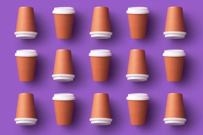 Five columns of disposable coffee cups on purple background
