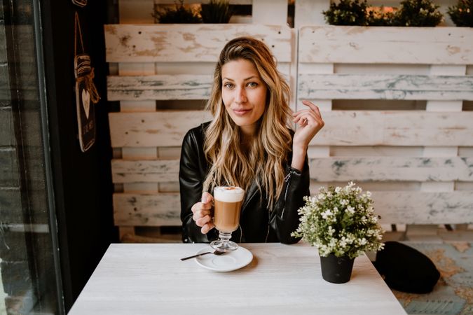 Woman drinking coffee from a glass
