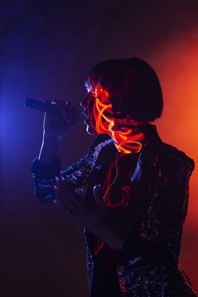 Stylish woman singing on stage