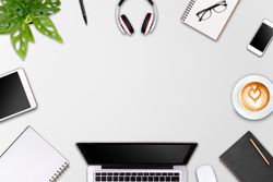 Modern workspace with laptop tablet, smartphone and coffee cup copy space on color background, top view, flat lay style
