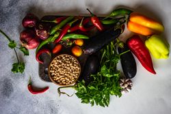 Fresh vegetables and beans on wooden board with copy space