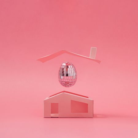 Pink disco ball Easter egg above minimalistic house