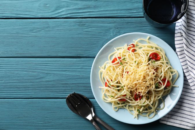 Composition with plate of tasty pasta on wooden background
