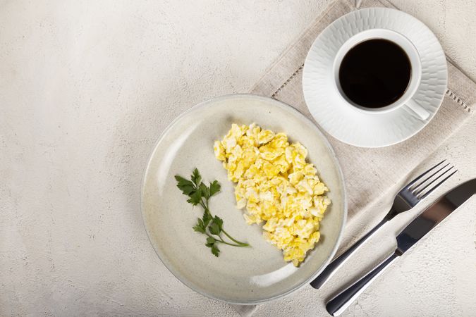 Breakfast with scrambled eggs on the table.