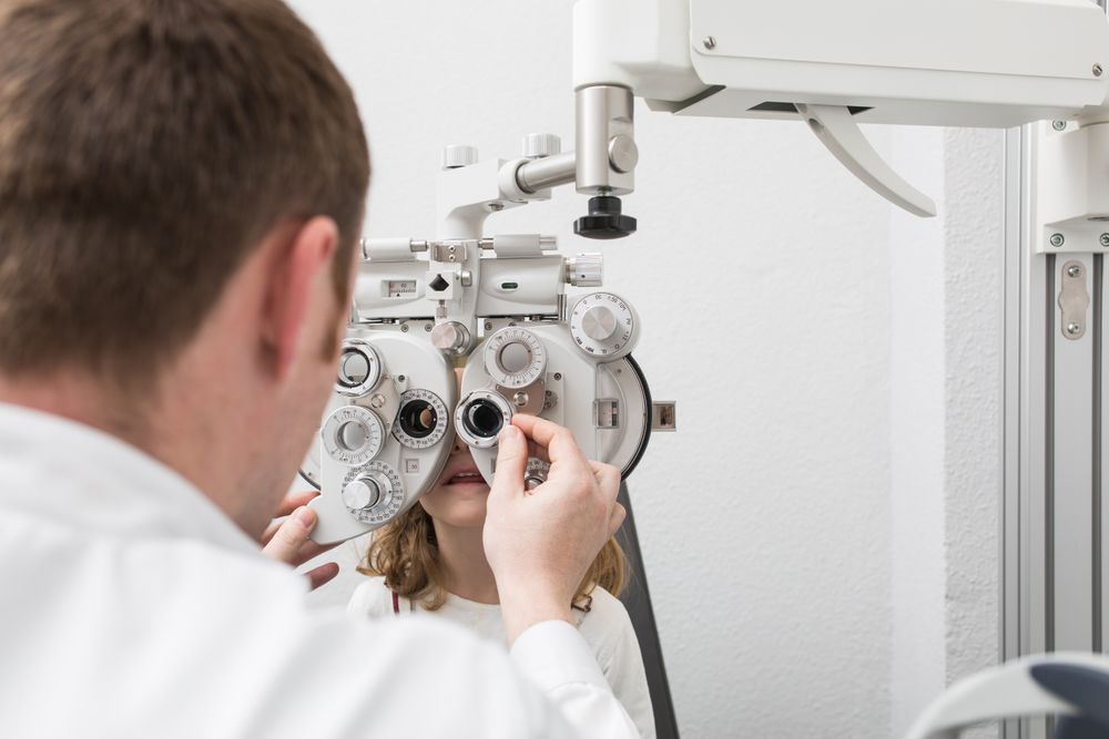 Optician testing a girl's eyes