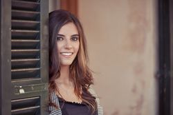 Content woman standing near door