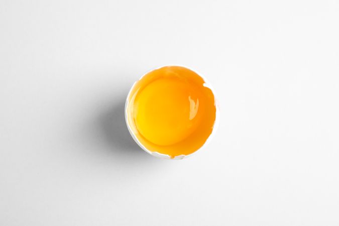 Half with yolk on light background, space for text