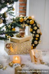 Christmas gift boxes and garland and tree decorated with gold baubles 5rKOZ4