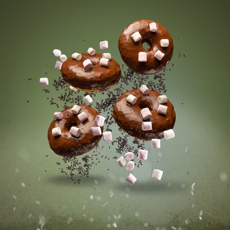 Flying chocolate glazed doughnuts