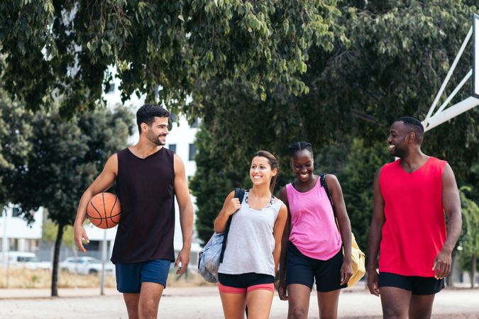 Group of interracial friends on their way to play basketball