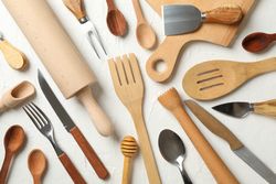 Composition with different kitchen cutlery on plain background