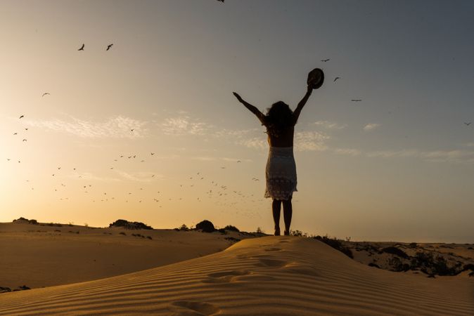 Active woman walking in dry desert barefoot