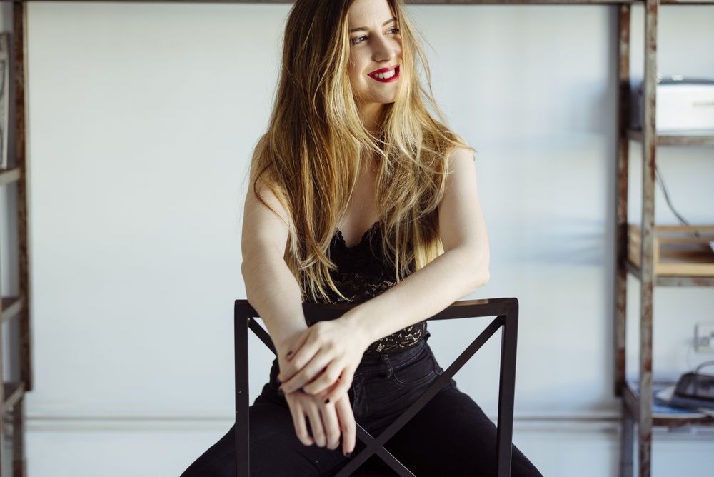 woman in bra sitting on chair