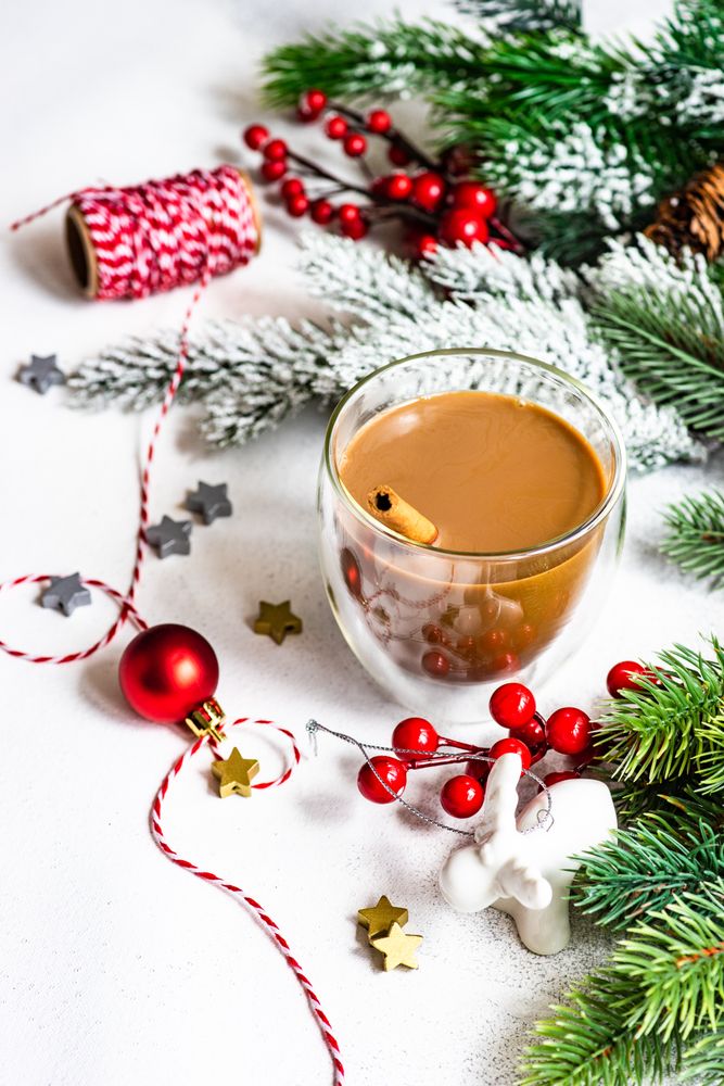 Christmas tree branch with cup of warming coffee