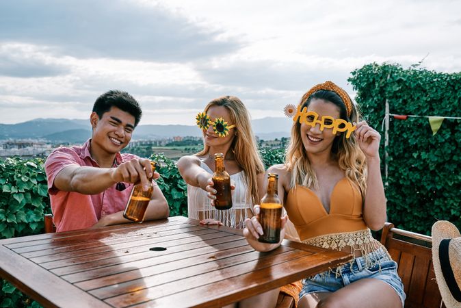 a group of disguised young people drinking beer