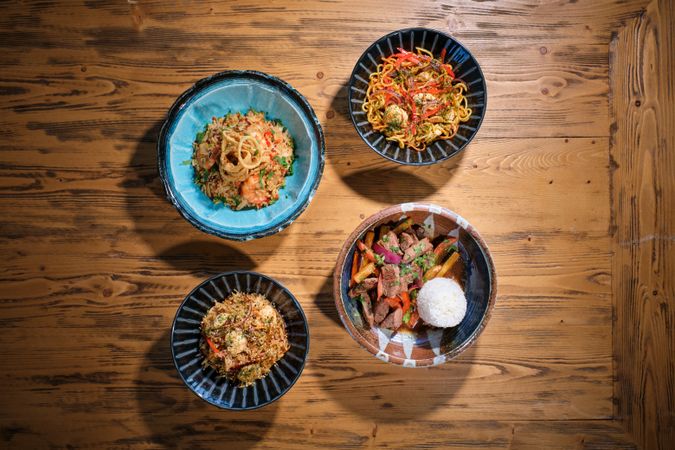 Appetizing dishes served in bowls on wooden table