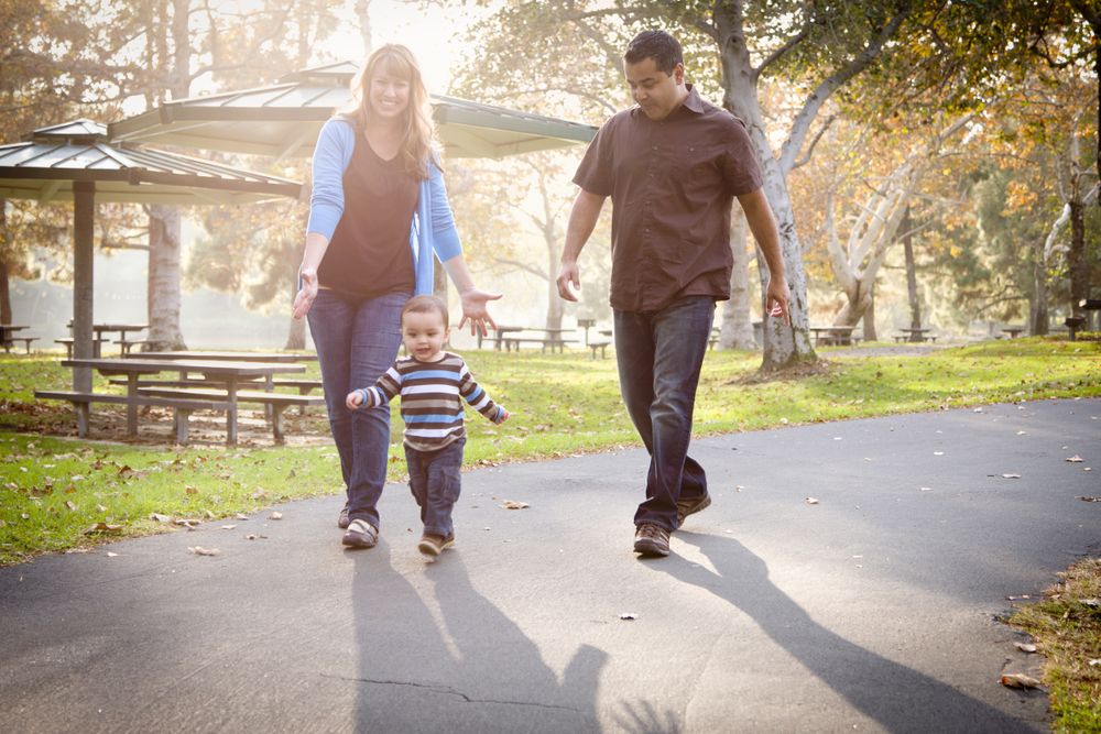 Happy Family Walking In The Park