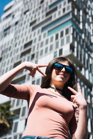 Portrait of 16 year old girl making funny gestures.