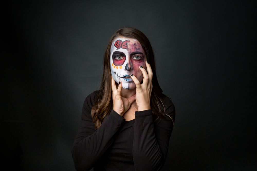 Young woman with creepy face paint