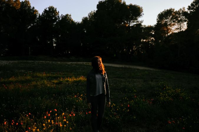 Woman walking on meadow and enjoying freedom