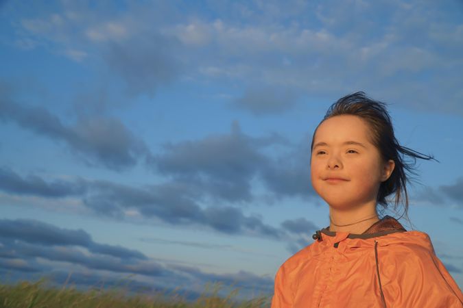 Beautiful little girl looking out to watch the sunset