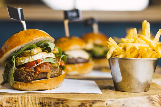 Juicy delicious burger and fried potato on table