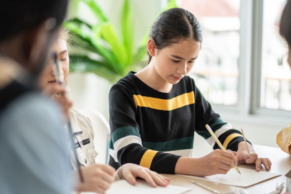 Young female student writing class