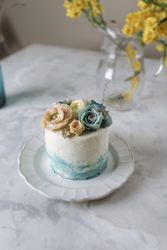 Buttercream flowers cake, blue and pastel peach colors