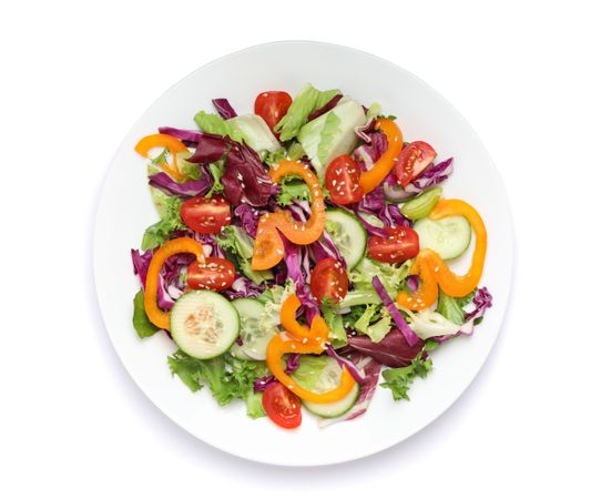 Plate with fresh salad isolated on plain background