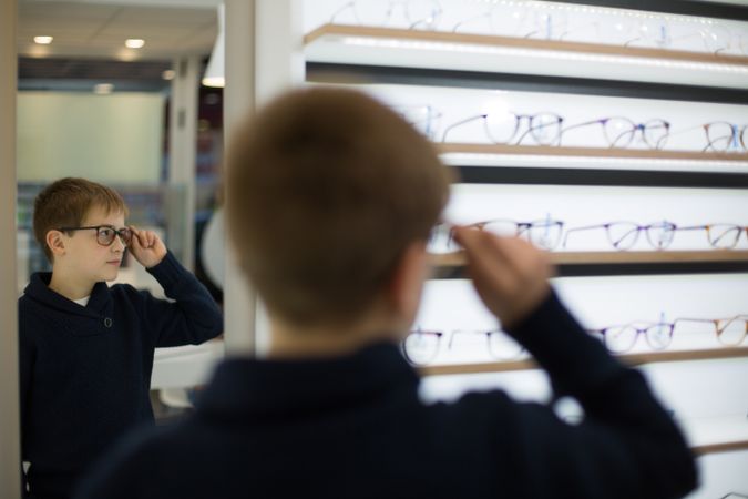 Young boy trying on glasses