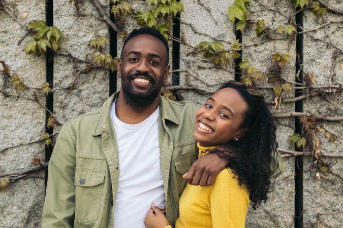 Black couple portrait smiling and holding each other