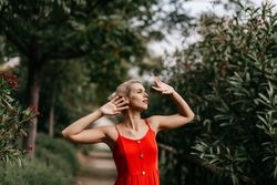 Dreamy young woman in summer garden
