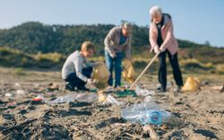 Mature volunteers cleaning the beach