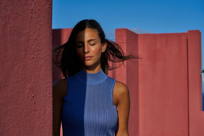 Woman with closed eyes in sunlight