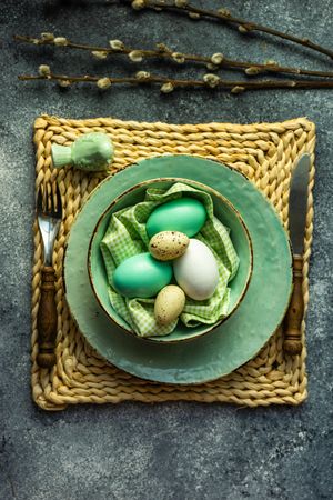 Top view of Easter holiday table setting with pastel eggs