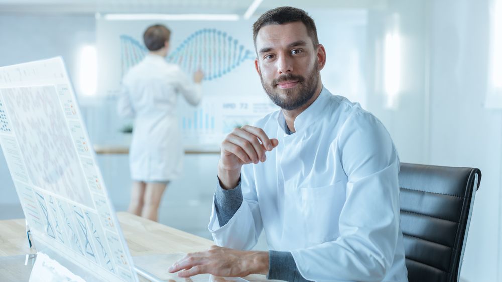 In the Futuristic Laboratory Male Scientists Looking into Camera.