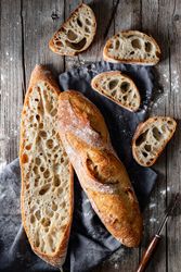 Fresh baguettes on checkered towel