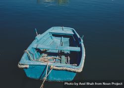 Small empty blue boat moored and floating in sea 5ow8m5