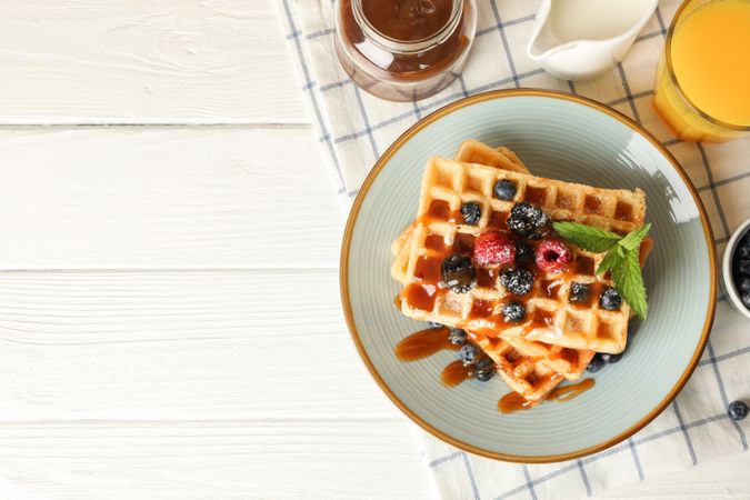 Composition of breakfast with belgian waffles, space for text